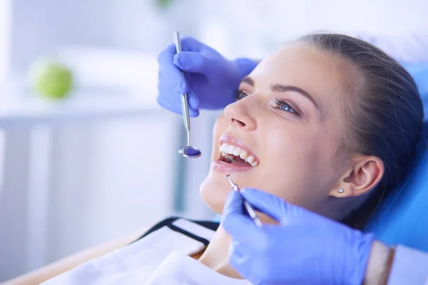 Mujer joven con la boca abierta examinando la inspección dental en el consultorio del dentista. — Foto de Stock