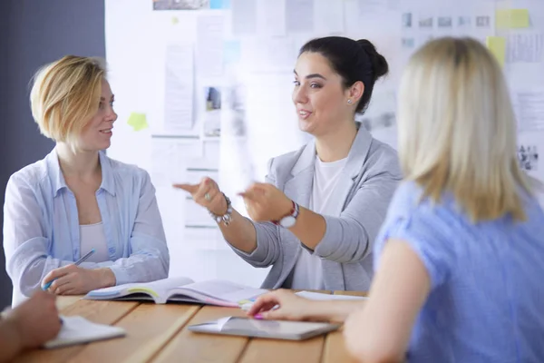 Young people studying with books on desk. Beautiful women and men working together. — Stock Photo, Image