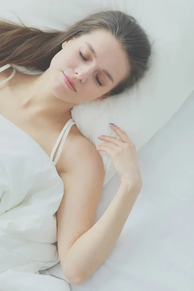 Beautiful girl sleeps in the bedroom, lying on bed. — Stock Photo, Image