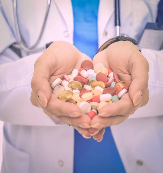 Doctor holding heap of drugs in a hand — Stock Photo, Image