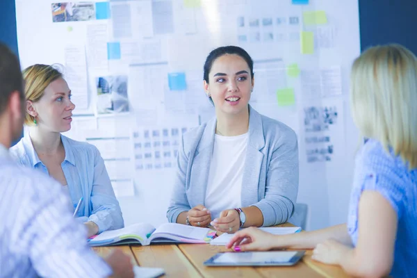 Young people studying with books on desk. Beautiful women and men working together. — Stock Photo, Image