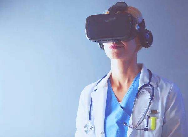 Female doctor wearing virtual reality glasses isolated on white background.