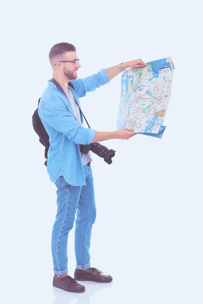 Junger Mann, der eine Landkarte auf weißem Hintergrund hält. junger Mann mit einer Landkarte auf weißem Hintergrund. ein Tourist im Urlaub. Suche nach Sehenswürdigkeiten. Abenteuerlustige. — Stockfoto