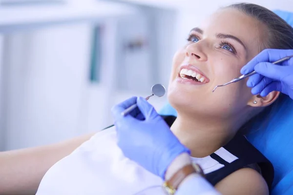 Mujer joven con la boca abierta examinando la inspección dental en el consultorio del dentista. — Foto de Stock