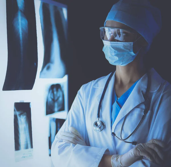 Image of attractive woman doctor looking at x-ray results. — Stock Photo, Image