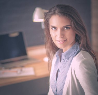 Masada oturan genç bir kadın..