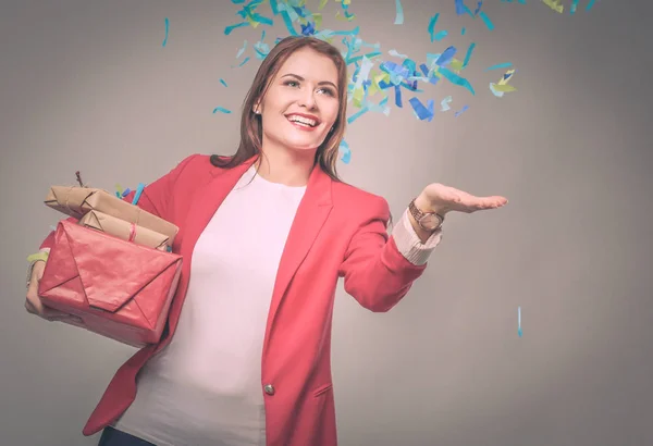 Beautiful happy woman with gift box at celebration party with confetti . Birthday or New Year eve celebrating concept — Stock Photo, Image