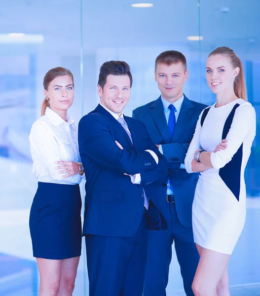 Young businesspeople standing in modern office lobby — Stock Photo, Image