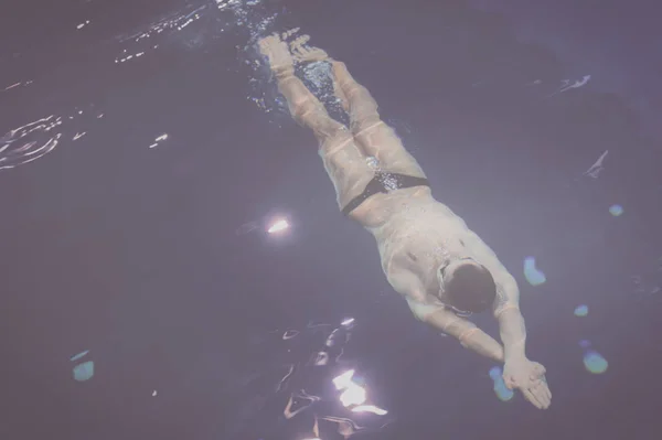 Homem nadador na piscina. Foto subaquática — Fotografia de Stock