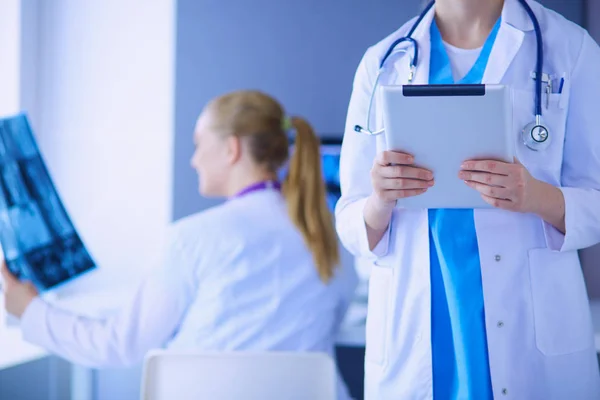 Close up shoot of doctors crossed hands and colleague with x-ray on the background. — Stock Photo, Image