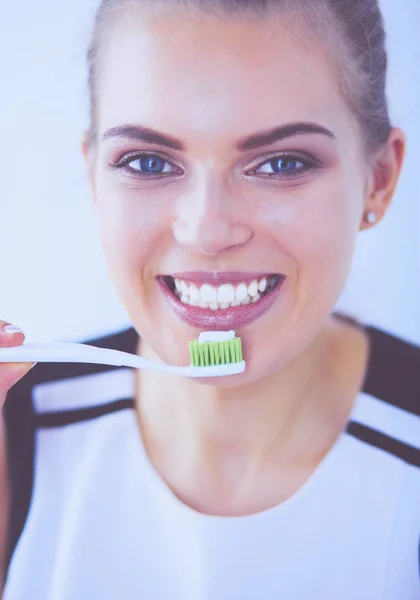 Joven chica bonita manteniendo la higiene bucal con cepillo de dientes . — Foto de Stock