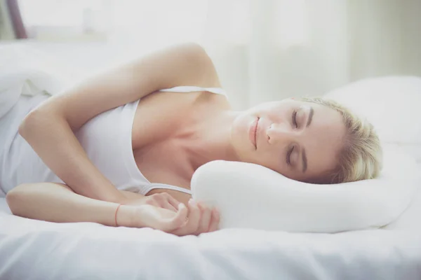 Красивая женщина лежит на кровати дома — стоковое фото