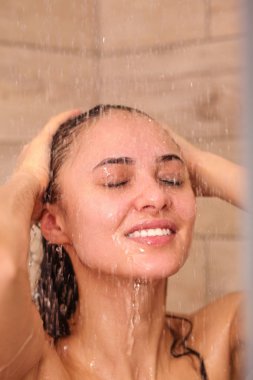 Genç beautyful kadın banyoda duş altında.