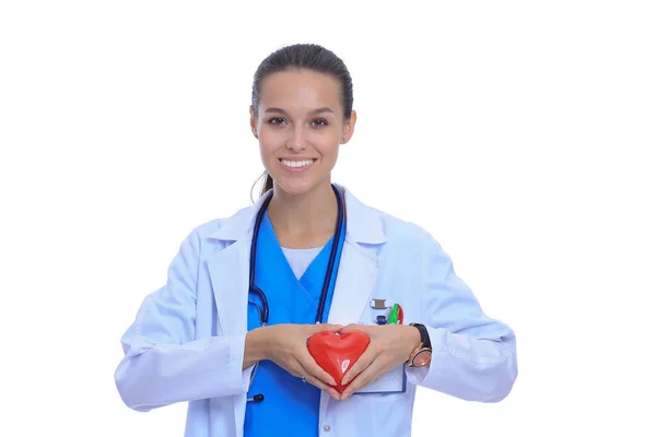 Positive female doctor standing with stethoscope and red heart symbol isolated. Woman doctor — Stock Photo, Image