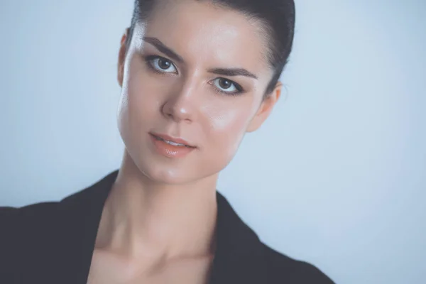 Young woman standing, isolated on gray background — Stock Photo, Image