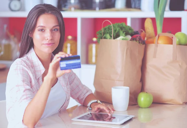 Young woman in the kitchen, using her ipad. Young woman — Stock Photo, Image