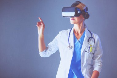 Sanal gerçeklik gözlüğü takan kadın doktor beyaz arka planda izole edilmiş..