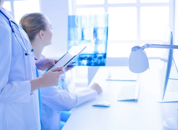 Close up shoot of doctor with tablet and colleague with x-ray on the background. — Stock Photo, Image