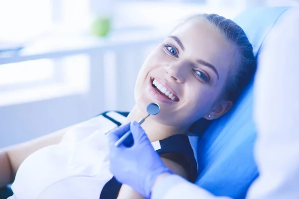 Jovem Paciente feminina com sorriso bonito examinando inspeção dentária no consultório odontológico. — Fotografia de Stock