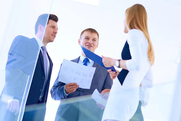 Portrait of young businessman in office with colleagues in the background . Portrait of young businessman. — Stock Photo, Image