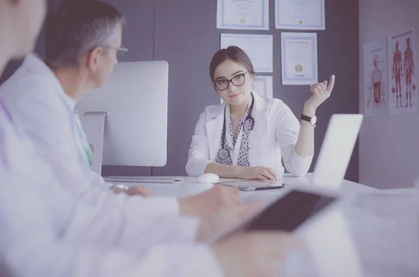 Serious medical team using a laptop in a bright office — Stock Photo, Image