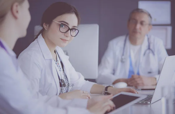 Serious medical team using a laptop in a bright office — Stock Photo, Image