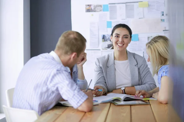 Young people studying with books on desk. Beautiful women and men working together. — Stock Photo, Image