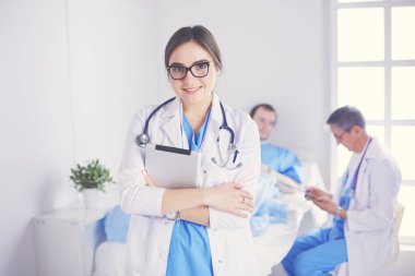 Hastane lobisinde tablet bilgisayar kullanan kadın doktor.