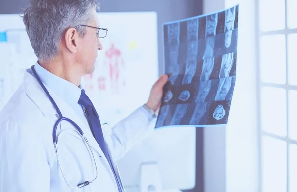 Male doctor writes notes on the clipboard in the hospital