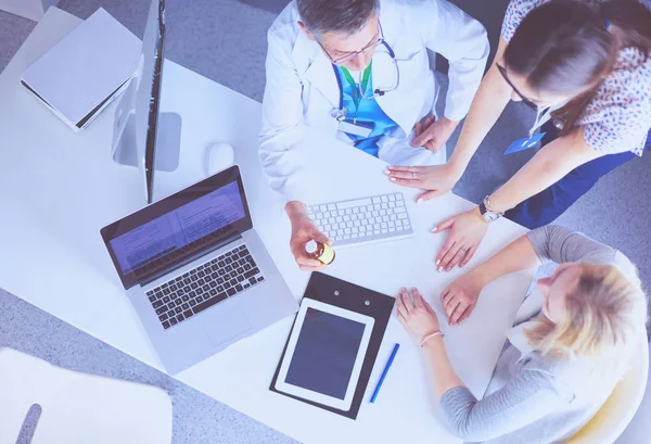 Doctor and patient discussing something while sitting at the table . Medicine and health care concept — Stock Photo, Image