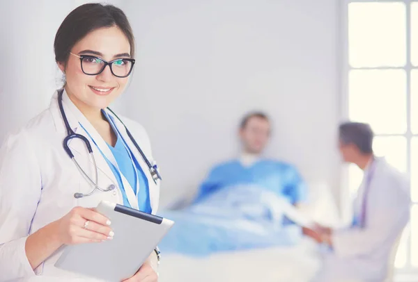 Female doctor using tablet computer in hospital lobby