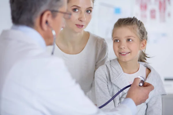 Meisje en arts met stethoscoop luisteren naar hartslag — Stockfoto