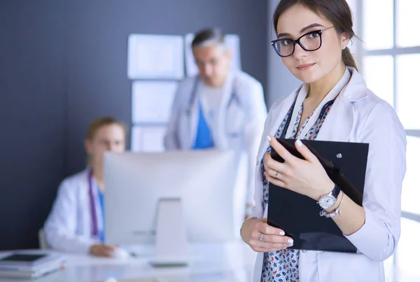 Woman doctor standing with stethoscope at hospital — Stock Photo, Image