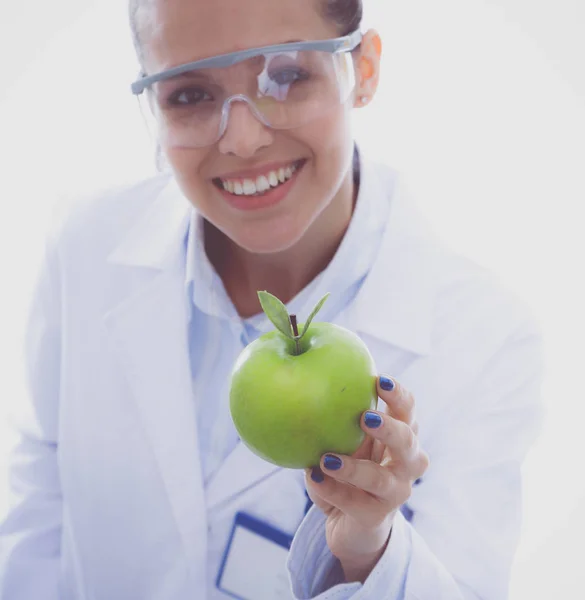 Врач-дантист женщина держит в руке зеленое свежее яблоко и зубную щетку. Врачи-дантисты. Женщины-врачи — стоковое фото