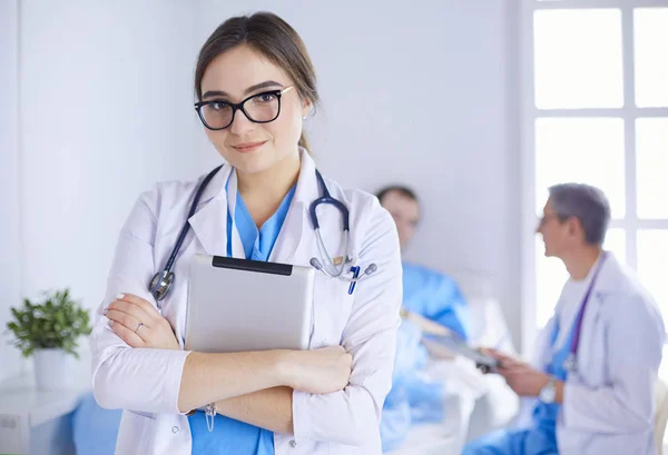 Female doctor using tablet computer in hospital lobby