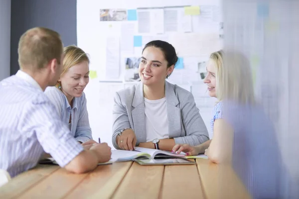 Young people studying with books on desk. Beautiful women and men working together. — Stock Photo, Image