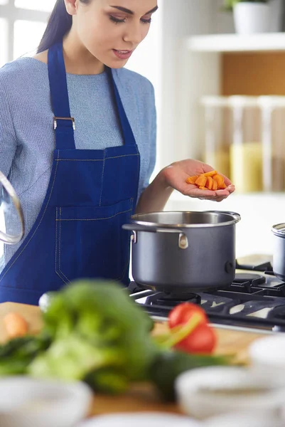 Cooking woman in kitchen with wooden spoon — Stock Photo, Image