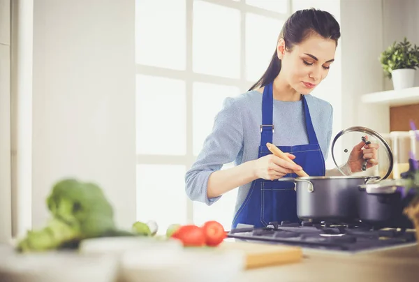 Vaření žena v kuchyni s dřevěnou lžičkou — Stock fotografie