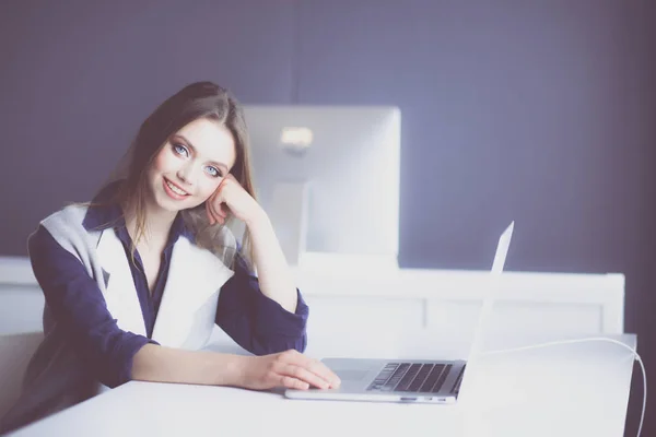 Giovane donna d'affari fiduciosa che lavora alla scrivania dell'ufficio e digita con un computer portatile — Foto Stock