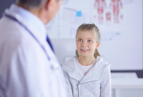 Portrait of a cute little girl and her doctor at hospital — Stock Photo, Image