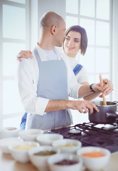Beautiful young woman using a digital tablet in the kitchen — Stock Photo, Image
