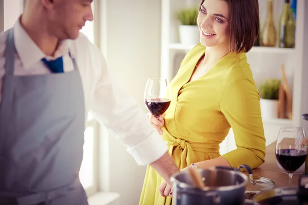 Beautiful young woman using a digital tablet in the kitchen — Stock Photo, Image