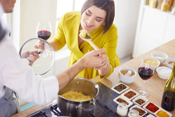 Evdeki mutfakta birlikte yemek pişiren çift.