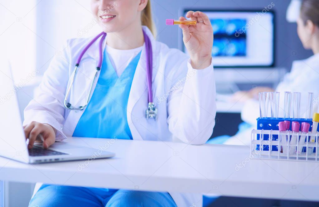 Two young female doctors at medical laboratory with tests.