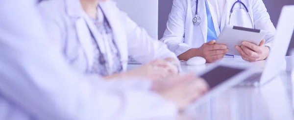 Serious medical team using a laptop in a bright office — Stock Photo, Image