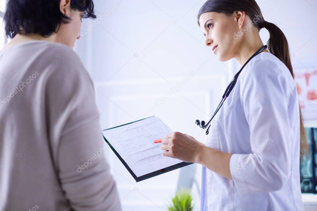 Beautiful female doctor explaining medical treatment to a patient