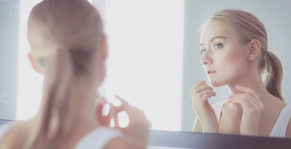 The beautiful young girl with a clean fresh skin touches with a hand a cheek — Stock Photo, Image