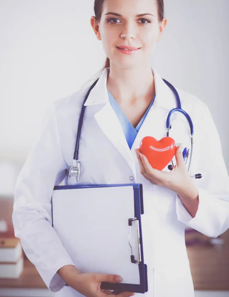 Mladá žena lékař drží červené srdce — Stock fotografie