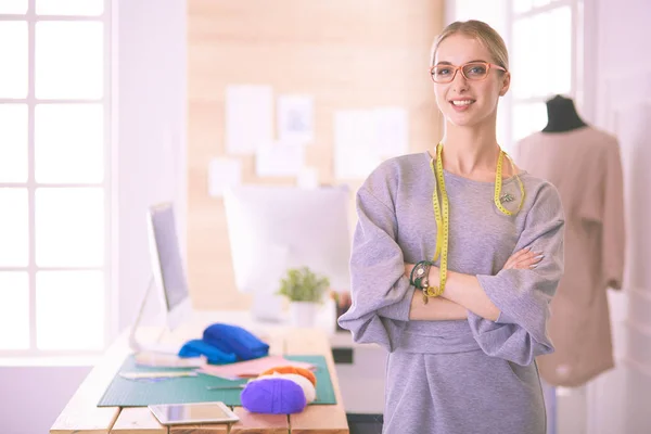 Beautiful fashion woman designer standing in studio