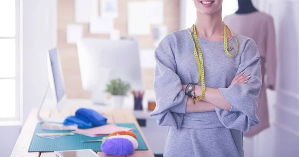 Beautiful fashion woman designer standing in studio